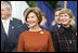 Mrs. Laura Bush and Mrs. Deborah Mullen, wife of the Chairman of the Joint Chiefs of Staff, Admiral Mike Mullen, watch the White House South Lawn ceremonies Oct. 13, 2008, for the State Arrival of Italian Prime Minister Silvio Berlusconi.