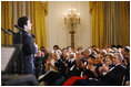 President George W. Bush and Mrs. Laura Bush are joined by Italian Prime Minister Silvio Berlusconi Monday evening, Oct. 13, 2008, as they listen to the Broadway cast of the Jersey Boys perform in the East Room of the White House.