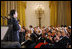 President George W. Bush and Mrs. Laura Bush are joined by Italian Prime Minister Silvio Berlusconi Monday evening, Oct. 13, 2008, as they listen to the Broadway cast of the Jersey Boys perform in the East Room of the White House.