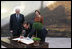 Italian Prime Minister Silvio Berlusconi follows Mrs. Laura Bush in signing the guest book Oct. 13, 2008 at the National Gallery of Art in Washington At left is Mr. Rusty Powell, Director of the National Gallery of Art, who led a tour of the exhibit "Pompeii and the Roman Villa; Art and Culture Around the Bay of Naples." The Mt. Vesuvius mural one of the backdrops for the exhibit.