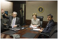 Mrs. Laura Bush acknowledges the Ladies in White during a video teleconference Thursday, Oct. 16, 2008, in the Situation Room of the White House. Mrs. Bush is joined by U.S. Secretary of Commerce Carlos Gutierrez, waving left, and interpreter Manuel Quiroz. Mrs. Laura Bush conveyed her continuous commitment, and that of the President, to support the Cuban people's aspirations for freedom.