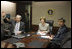 Mrs. Laura Bush acknowledges the Ladies in White during a video teleconference Thursday, Oct. 16, 2008, in the Situation Room of the White House. Mrs. Bush is joined by U.S. Secretary of Commerce Carlos Gutierrez, waving left, and interpreter Manuel Quiroz. Mrs. Laura Bush conveyed her continuous commitment, and that of the President, to support the Cuban people's aspirations for freedom.