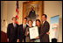 Mrs. Laura Bush presents the Fifth Annual Preserve America History Teacher of the Year award to David Mitchell, right, Friday, Oct. 24, 2008, at the Union League Club in New York City. She is joined by Dr. James Basker, President, Gilder Lehrman Institute of American History, left, and David Mitchell's students from Masconomet Regional High School in Boxford, Mass., David Burbank, 17, and Molly Byman, 18. The award notes the importance of teaching history and highlights the Preserve America initiative.