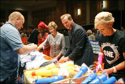 Mrs. Laura Bush, joined by Mrs. Cindy McCain, right, help HIV and AIDS advocate Princess Kasune Zulu, left, and One Chairman and CEO David Lane assemble care-giver packages at the ONE campaign event Tuesday, Sept. 2, 2008 at the Minneapolis Convention Center in Minneapolis, in support of health care workers who treat AIDS patients in African countries.