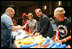 Mrs. Laura Bush, joined by Mrs. Cindy McCain, right, help HIV and AIDS advocate Princess Kasune Zulu, left, and One Chairman and CEO David Lane assemble care-giver packages at the ONE campaign event Tuesday, Sept. 2, 2008 at the Minneapolis Convention Center in Minneapolis, in support of health care workers who treat AIDS patients in African countries.