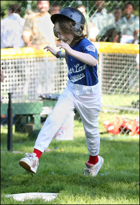 Stars player Bridget Donahue of Westborough, Mass., leaps for home plate during action in the Tee Ball on the South Lawn: A Salute to the Troops game Sunday, Sept. 7, 2008 at the White House, played by the children of active-duty military personnel.