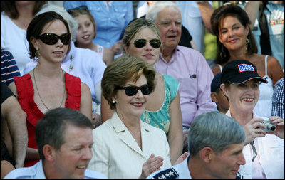 Mrs. Laura Bush is joined by her daughters, Barbara, background-left, and Jenna, background-right, as they watch action at the Tee Ball on the South Lawn: A Salute to the Troops game Sunday, Sept. 7, 2008 at the White House, played by the children of active-duty military personnel.