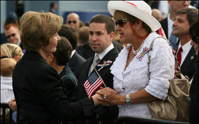 Mrs. Laura Bush speaks with a family member attending the Pentagon Memorial dedication ceremony Thursday, Sept. 11, 2008 at the Pentagon in Arlington, Va., where 184 memorial benches were unveiled honoring all innocent life lost when American Airlines Flight 77 crashed into the Pentagon on Sept. 11, 2001.