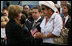 Mrs. Laura Bush speaks with a family member attending the Pentagon Memorial dedication ceremony Thursday, Sept. 11, 2008 at the Pentagon in Arlington, Va., where 184 memorial benches were unveiled honoring all innocent life lost when American Airlines Flight 77 crashed into the Pentagon on Sept. 11, 2001.