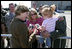 Mrs. Laura Bush offers photos of the Bush family dogs, Scottish Terrier's Barney and Mrs. Beazley, and the cat, Willie, to a little girl before departing from Forbes Field in Topeka, Kan., on Tuesday, Sept. 16, 2008. She had just greeted members of the military gathered to see her departure from the air field.