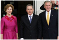 President George W. Bush and Mrs. Laura Bush greet Colombian President Alvaro Uribe on the North Portico Saturday, Sept. 20, 2008, for a social dinner at the White House.