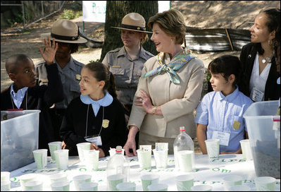 Mrs. Laura Bush and children from the Adam Clayton Powell Jr. Elementary School (P.S. 153) and the Boys and Girls Club of Harlem do 'cup planting' as part of the First Bloom program at the Hamilton Grange National Memorial in New York City, Sept. 24, 2008. The children will take care of the seedlings in the cups throughout the winter and plant them in the park in the spring.