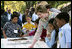 Mrs. Laura Bush and children from the Adam Clayton Powell Jr. Elementary School (P.S. 153) and the Boys and Girls Club of Harlem do a 'soil sampling' as part of the First Bloom program at the Hamilton Grange National Memorial in New York City, Sept. 24, 2008. The activity helps children learn about the characteristics of local soil and thus the kinds of plants best suited to the area. The park is the historic home of Alexander Hamilton. 