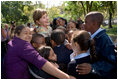 Mrs. Laura Bush receives a big group hug from children visiting from the Adam Clayton Powell Jr. Elementary School (P.S. 153) and the Boys and Girls Club of Harlem at the conclusion of a First Bloom program at the Hamilton Grange National Memorial in New York City, Sept. 24, 2008. The First Bloom program is a national conservation education program for the National Park Foundation that encourages young people to protect the environment in America's National Parks and in their own back yards. 