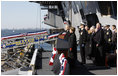 President George W. Bush stands with Mrs. Laura Bush during the playing of the national anthem at the commissioning ceremony of the USS George H. W. Bush (CVN 77) aircraft carrier Saturday, Jan 10, 2009 in Norfolk, Va., in honor of his father, former President George H. W. Bush, seen at right.