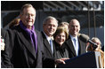 President George W.Bush stands with his father, former President George H.W. Bush and Mrs.Laura Bush during the commissioning ceremony of the USS George H.W. Bush (CVN 77) aircraft carrier Saturday, Jan 10, 2009 in Norfolk, Va.