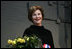 Mrs. Laura Bush stands with a bouquet presented along with the Department of Defense Outstanding Public Service Award by U.S. Secretary of Defense Robert Gates during a military appreciation Tuesday, Jan. 6, 2009, in honor of President George W. Bush's tenure as Commander-in-Chief.