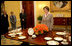 Mrs. Laura Bush meets reporters as she announces two new White House china patterns, Wednesday, Jan. 7, 2009 in the Family Dining Room of the State Floor of the White House for their unveiling of the George W. Bush State China and the Magnolia Residence China. The George W. Bush State China was inspired from a Madison-era dinner service. The Magnolia Residence China is in the picture foreground and the George W. Bush State China is on the left side of the table. With Mrs. Bush from left are Amy Zantsinger, White House Social Secretary, Nancy Clarke, White House Florist, and Bill Allman, White House Curator.