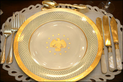 The George W. Bush State China, unveiled Wednesday, Jan. 7, 2009, at the White House by Mrs. Laura Bush, has a gold rim with a green basket-weave pattern and a historically-inspired gold eagle throughout the 14-piece place setting. The 320-place setting pattern will allow the White House to accommodate larger Rose Garden dinners and cover any breakage. The china was paid for by the White House Historical Association Acquisition Trust, a non-profit organization.