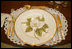 The Magnolia Residence China was unveiled Wednesday, Jan. 7, 2009, by Mrs. Laura Bush at the White House with plates whose magnolia decoration give the china it's name. Other pieces show a varied and detailed pattern from nature. There are 75 place settings of the service which were purchased by the White House Historical Association through the George W. Bush Redecoration Fund. This new china, by Pickard China of Antioch, Ill., was designed in Virginia and hand painted in Hungary.