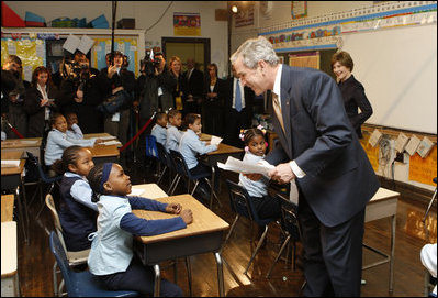 President George W. Bush talks with a young student during his visit with Mrs. Laura Bush to a second grade class Thursday, Jan. 8, 2009 at the General Philip Kearny School in Philadelphia. President Bush followed his class visit with an address on the No Child Left Behind Act, urging Congress to strenghten and reauthorize the legislation.