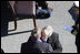 President George W. Bush embraces his father, former President George H. W. Bush, following his remarks honoring his father during the commissioning ceremony of the USS George H. W. Bush (CVN 77) aircraft carrier Saturday, Jan 10, 2009 in Norfolk, Va.