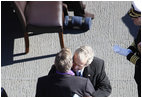 President George W. Bush embraces his father, former President George H. W. Bush, following his remarks honoring his father during the commissioning ceremony of the USS George H. W. Bush (CVN 77) aircraft carrier Saturday, Jan 10, 2009 in Norfolk, Va.