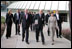 The Eiffel Tower stands tall in the background as Mrs. Laura Bush walks with Stephane Martin, President of the Musee du quai Branly, center, in Paris Monday, Jan. 15, 2007. Mrs. Bush toured the museum with US Ambassador Craig Stapleton, left, and his wife Mrs. Stapleton. 