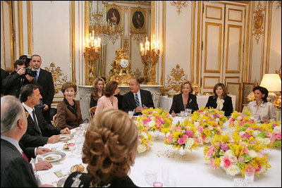 Mrs. Laura Bush attends a luncheon hosted by Madame Bernadette Chirac for the Conference on Missing and Exploited Children at the Elysee Palace in Paris Wednesday, Jan. 17, 2007. President Jacque Chirac of France is pictured in the center. 