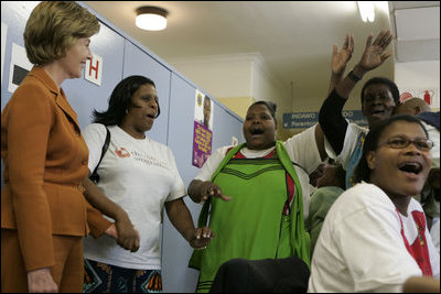 Laura Bush is greeted by a chorus of singers while visiting Mothers to Mothers-to-Be in Cape Town, South Africa, Tuesday, July 12. The program provides counseling, education and support to HIV/AIDS infected women during pregnancy. 