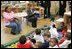 Laura Bush joins pre-school teacher Georgianna Ragland's class in a song during her visit to the Germantown Boys and Girls Club Tuesday, Feb. 3, 2005 in Philadelphia. Mrs Bush highlighted the importance of programs that support youth, especially at-risk boys.