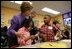 Laura Bush talks with Providence Family Support Center after-school program participants Isaiah Baynes, right, and Carlaija Whitehead during her visit and President Bush's to Pittsburgh to highlight the program's efforts to help area youth Monday, March 7, 2005.