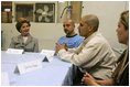 Laura Bush talks with, from left, Gabriel Flores, Archie Dominguez and Shirley Torres during a discussion at Homeboy Industries in Los Angeles April 27, 2005. Homeboys Industries is an job-training program that educates, trains and finds jobs for at-risk and gang-involved youth.