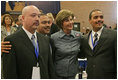 Laura Bush poses for photos with Homeboy Industries representatives, Gustavo Mojica, Herbert Corleto and Gabriel Hinojos, Thursday, Oct. 27, 2005 at Howard University in Washington, at the White House Conference on Helping America's Youth. 