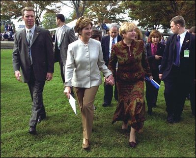 Laura Bush and Ludmila Putina, wife of Russian Federation President Vladimir Putin, stroll across the lawn of the Capitol visiting the tents of authors and story tellers at the Second Annual National Book Festival Saturday, October 12, 2002. White House photo by Susan Sterner.