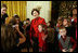 Mrs. Laura Bush poses for a photo with a young guest following the performance of the Ford's Theatre cast members presentation of “A Christmas Carol,” Monday, Dec. 3, 2007, at the White House Children’s Holiday Reception.