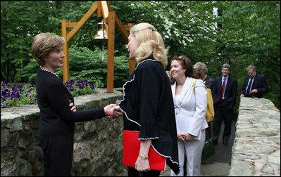 Mrs. Laura Bush greets the directors of Presidential Libraries Wednesday, June 4, 2008, at the entrance to Camp David's Evergreen Chapel in Thurmont, Maryland. Mrs. Bush shakes hands with Ms.Nancy Smith, Director of the National Archives' Presidential Material Staff in Alexandria, VA.