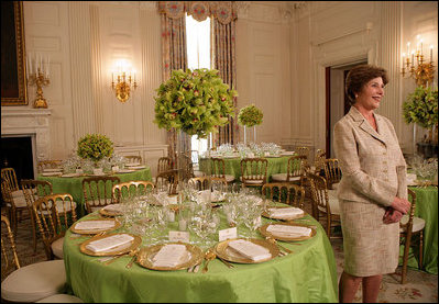 Mrs. Laura Bush discusses the motifs and entertainment for the official dinner honoring His Excellency Junichiro Koizumi, Prime Minister of Japan, in the State Dining Room during a media preview Thursday, June 29, 2006. "I think it's going to be a very fun evening," said Mrs. Bush. "Our orchestra is the Brian Setzer Orchestra. He'll play a lot of both the President's and Prime Minister Koizumi's favorites, and he's especially known for his guitar. So I think that will be terrific." White House photo by Shealah Craighead 