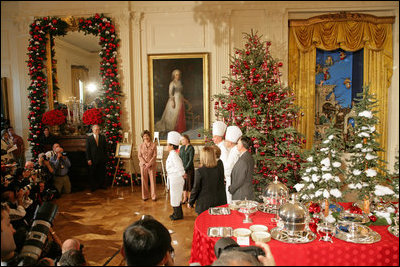 Mrs. Laura Bush and White House Chef Cris Comerford, center, explain the holiday reception menu to the press in the State Dining Room Thursday, Nov. 30, 2006. White House photo by Shealah Craighead 