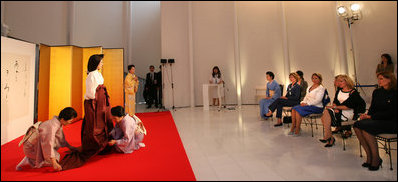 Mrs. Laura Bush and wives of the G8 Summit leaders view a demonstration of the complexities of Junihitoe, a 12-layered ancient kimono, during a traditional Japanese cultural program for the G8 Summit spouses at the Windsor Hotel Toya Resort and Spa's Bridal Salon in Toyako, Japan on July 7, 2008. The event celebrates the 1000th anniversary of the Tale of Genji, a Japanese classic novel written by Lady Murasaki. Junihitoe means 12 layers, and is an example of the formal court dress worn by women during Murasaki's time.