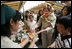 Mrs. Laura Bush samples the food at the Hokkaido Marche farmer's market in Makkari Village Tuesday, July 8, 2008, as part of the G8 spouses program. The small village on the northern Japanese island of Hokkaido is known for its lilies and its potatoes, and the market, organized especially for the occasion of the G8 Summit, showcased locally grown produce.