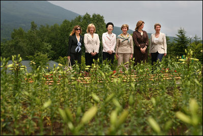 With Mt. Yoteizan as a backdrop, Mrs. Laura Bush and the G8 spouses pause Tuesday, July 8, 2008, for a photo in the village of Makkari, known for its lilies and potatoes, on the northern Japanese island of Hokkaido. From left are Mrs. Margarida Uva Barosso, wife of the President of European Commission; Mrs. Laureen Harper, wife of the Prime Minister of Canada; Mrs. Kiyoko Fukuda, wife of the Prime Minister of Japan; Mrs. Laura Bush; Mrs. Sarah Brown, wife of the Prime Minister of the United Kingdom; and Mrs. Svetlana Medvedeva, wife of the President of Russia.