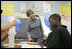 Mrs. Laura Bush watches a student demonstrate an experiment with static electricity and a balloon at the New Orleans Charter Science and Mathematics High School Thursday, April 19, 2007, in New Orleans, La. Originally created as a half-day program in 1992, the program reorganized itself as The New Orleans Charter Science and Mathematics High School after Hurricane Katrina sent the city’s school system into a state of crisis.