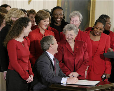 President George W. Bush and Laura Bush joke with heart disease survivors after signing the American Heart Month Proclamation in the East Room Feb. 2, 2003.