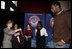 Mrs. Laura Bush holds an National Basketball Association basketball jersey presented to her by NBA player Mr. Greg Oden of the Portland Trail Blazers, during the regional conference on Helping America's Youth at the Portland Center for the Performing Arts in Portland, Ore. Also attending the presentation are, from left, Ms. Robyn Williams, executive director, Portland Center for the Performing Arts; Mrs. Mary Oberst, first lady of Oregon; and student, Ms. Shantel Monk.