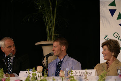 Mrs. Laura Bush listens to Paul Alt, left, a Team Focus mentor to Tony Javens, center, during a visit Thursday, June 21, 2007, to Team Focus’s National Leadership Camp, in Mobile, Ala.