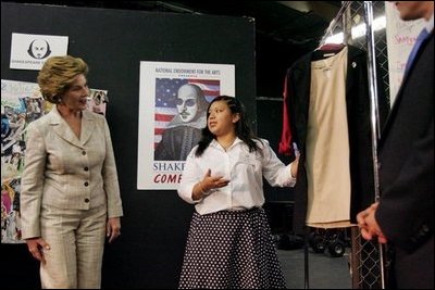 Laura Bush looks at costumes designed by members of the Will Power to Youth program before watching a performance of "Romeo and Juliet" at the Shakespeare Festival/LA's theater in Los Angeles April 26, 2005. Students in the program write their own versions of Shakespeare's plays, create the music, costumes and construct the sets for each production.