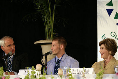  Mrs. Laura Bush listens to Paul Alt, left, a Team Focus mentor to Tony Javens, center, during a visit Thursday, June 21, 2007, to Team Focus’s National Leadership Camp, in Mobile, Ala.