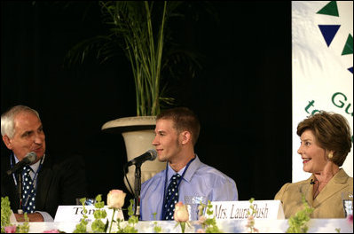 Mrs. Laura Bush listens to Paul Alt, left, a Team Focus mentor to Tony Javens, center, during a visit Thursday, June 21, 2007, to Team Focus's National Leadership Camp, in Mobile, Ala.