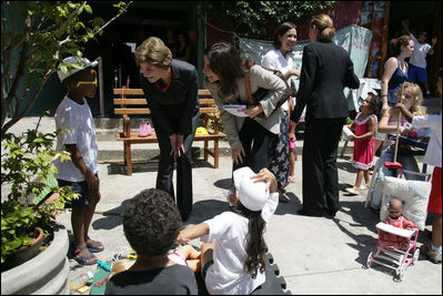 Mrs. Laura Bush talks with a little boy at Projecto Aprendiz Friday, March 9, 2007, in Sao Paulo, Brazil. White House photo by Shealah Craighead